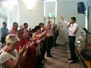 People surrender to Jesus at altar